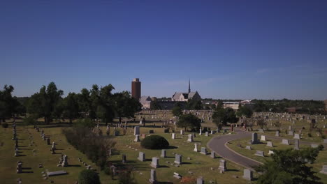 Aerial-dolly-through-a-graveyard-with-clear-blue-skies