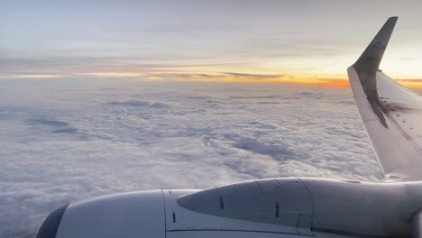 Flying-on-an-KLM-airplane-over-a-sea-of-clouds-at-sunset