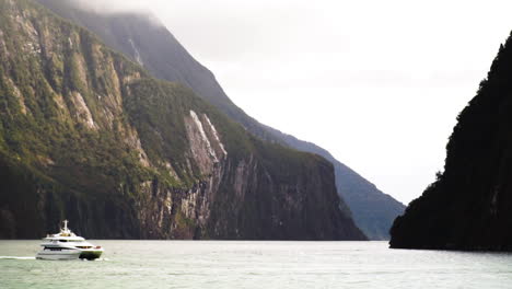 Tourist-boat-sailing-in-Milford-Sound-on-calm-day