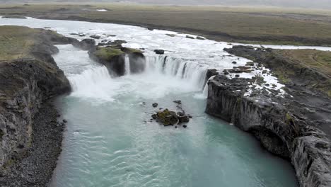 Aerial-shot-towards-Godafoss-glacier-blue-green-waterfall-in-Iceland