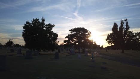 Low-aerial-dolly-through-the-cemetery-with-dying-light