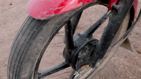 close-up-shot-of-the-front-wheel-with-the-drum-brake-of-a-bajaj-motorcycle-imported-to-africa