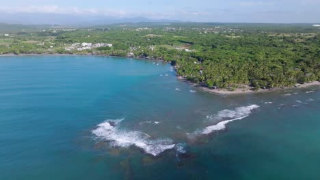 Aerial-view-of-PLAYA-PALENQUE-with-beautiful-coastline,blue-Caribbean-sea-and-green-rural-landscape-in-background---San-Cristobal,-Dominican-Republic