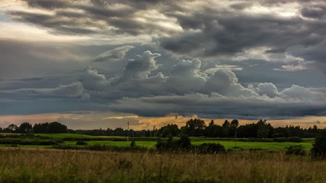 Time-Lapse-of-dark-and-ominous-storm-clouds-forming-over-a-meadow
