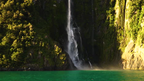 A-beautiful-waterfall-falling-into-colored-lake-on-a-sunny-day