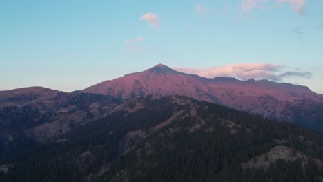 A-drone-flies-at-a-high-altitude-revealing-the-peak-of-mountain-Smolikas-in-Greece-while-the-sun-sets
