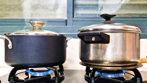 Two-pots-on-the-hob,-cooking-on-a-gas-stove