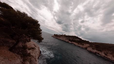 FPV-aerial-above-the-mediterranean-sea-and-cliffs-in-southern-France