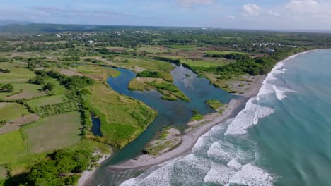 Aerial-view-showing-river-mouth-of-Rio-Nizao-in-San-Cristobal-beside-Caribbean-Sea,Dominican-Republic