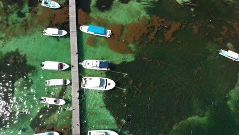 Drone-flight-over-boats-in-ocean-at-Playa-del-Carmen,-Mexico