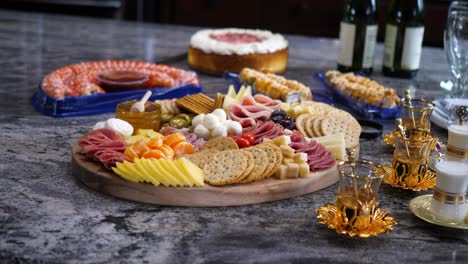 Finger-food-charcuterie-board-platter-with-mixed-foods-like-ham-cheese-and-crackers