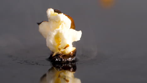 Popcorn-Kernel-Pops-in-Slow-Motion,-Cooks-On-Heat,-Splits-and-bursts-Open,-close-up