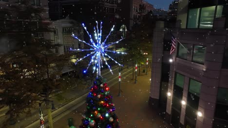 Tight-aerial-of-lit-star-on-Christmas-tree-in-downtown-USA-city