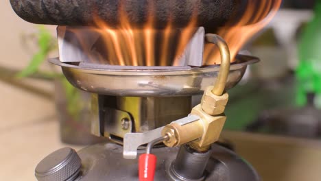 Food-Cooking-On-Small-portable-Kerosene-camp-stove-with-red-flame-burns,-close-up