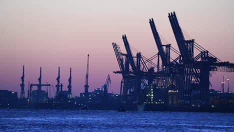 Cranes-of-container-terminal-in-the-port-of-Hamburg,-morning-light-before-sunrise,-blue-hour,-economy,-market