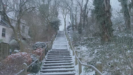 Looking-up-Outdoor-Steps,-Snowy-Winter-Weather,-Trees-and-London-Victorian-Housing,-Slow-Motion