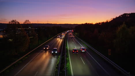 Time-lapse-static-shot-from-a-bridge-onto-a-busy-highway-with-a-lot-of-traffic-with-cars-and-trucks-during-the-sunset-in-the-holiday-evening-traffic