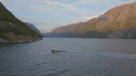 boat-driving-in-Lysfjord-in-Norway-in-the-sunrise
