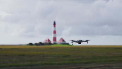 Drone-flying-towards-lighthouse-destination-quickly.-Moving-further