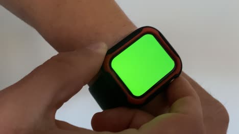 Man-using-his-green-screened-smart-watch