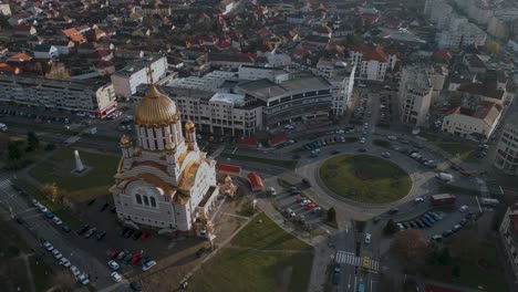 Panorama-Aerial-drone-flight-around-a-roundabout-and-the-Orthodox-Church-Catedrala-Sfântul-Ioan-Botezătorul-and-castle-Cetatea-Făgărașului-of-Fagaras-in-Romania---Făgăraș-in-România---bird-view