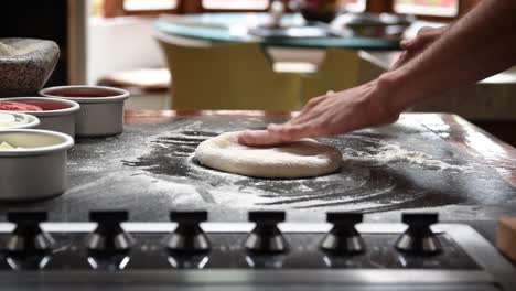 Home-made-sourdough-pizza-being-stretched-with-flour