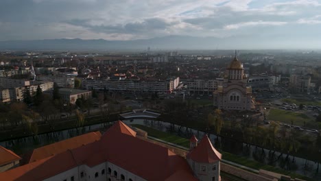 Ascending-aerial-drone-flight-around-with-castle-Cetatea-Făgărașului-and-the-Orthodox-church-Catedrala-Sfântul-Ioan-Botezătorul-of-Făgăraș-in-România---bird-view-of-Fagaras-in-Romania-in-winter-2022