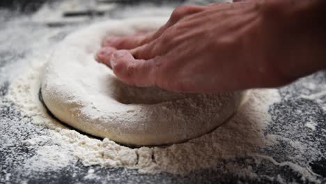Chef-stretching-sourdough-with-flour-for-a-home-made-pizza