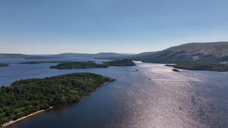 Sunny-Day-on-Loch-Lomond-Flying-Above-Islands-with-Boats-Out-Cruising-Short