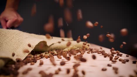 Coffee-Beans-Dropped-On-Table-4K-Slow-Motion