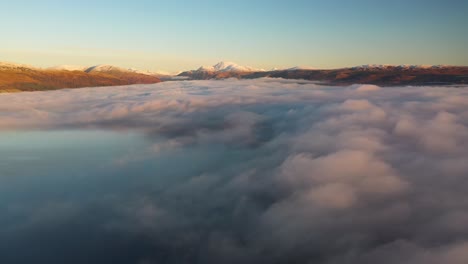 Beautiful-sunrise-over-Loch-Lomond-flying-above-the-clouds-with-Ben-Lomond-in-the-distance