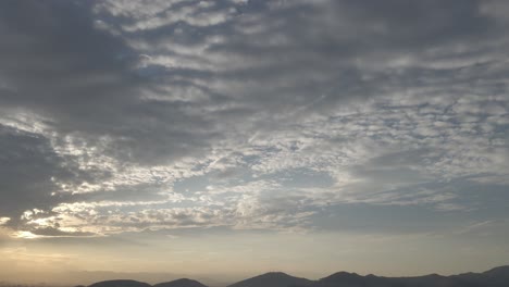 Tilted-up,-pan-Dusk-shot-of-a-sky-with-Mountain-in-far-distance