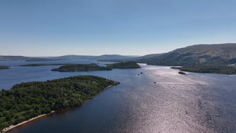 Sunny-Day-on-Loch-Lomond-Flying-Above-Islands-with-Boats-Out-Cruising