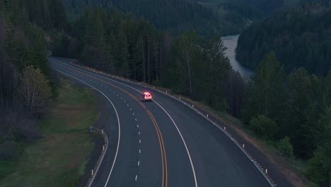 Drone-Shot-of-Emergency-Fire-Vehicle-Driving-on-Highway-next-to-River-at-night