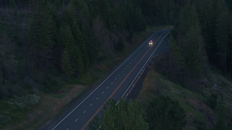 Drone-Shot-of-Emergency-Fire-Vehicle-Driving-on-Highway-next-to-River-at-night
