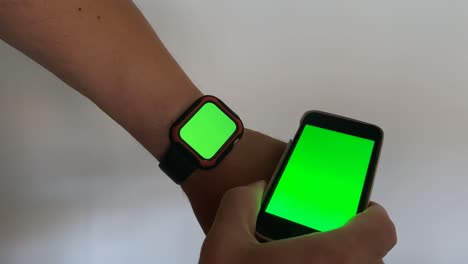Man-using-smartwatch-with-chroma-key-close-up