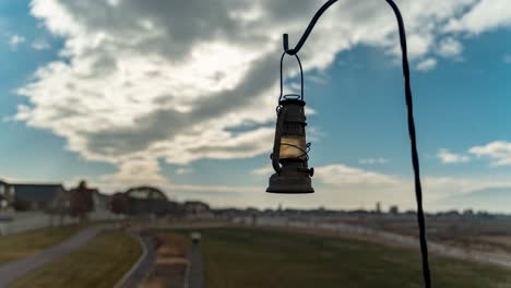 An-antique-lantern-in-focus-with-the-cloudscape-background-blurred---parallax-motion-time-lapse