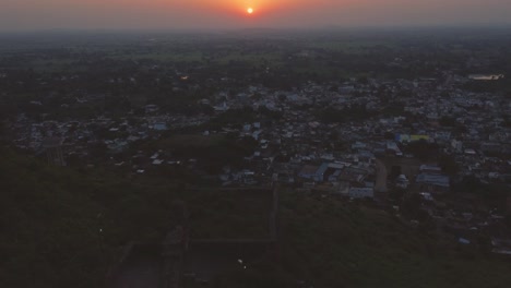 Aerial-drone-shot-of-a-sunrise-in-a-city-at-Narwar-,-Shivpuri-,-Madhya-Pradesh-,-India
