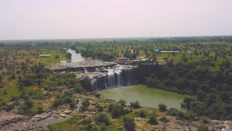 Aerial-drone-shot-of-a-Waterfall-flowing-into-a-river-at-Madhya-Pradesh-,-India