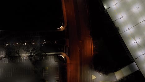 A-top-down-view-over-an-illuminated-road-at-night