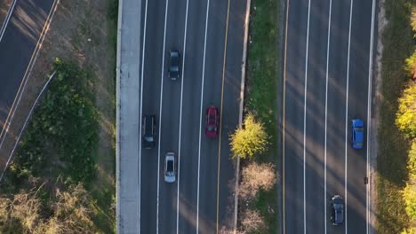 An-aerial,-top-down-shot-over-a-highway,-shot-in-slow-motion