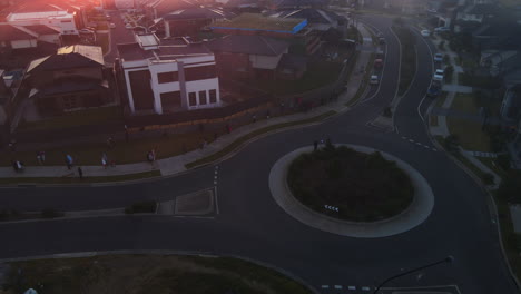 High-view-of-Roundabout-at-dawn-with-a-glint-of-sun-frozen-stationary-people