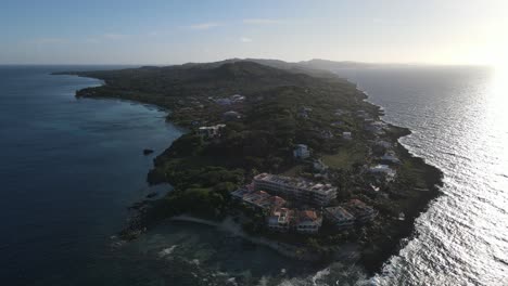 Caribbean-island-aerial-drone-footage-at-sunset-of-Bay-Islands-Roatan-in-Honduras