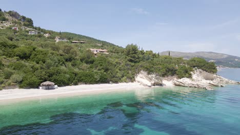 Drone-descends-onto-beach-in-Zakynthos-island,-Greece