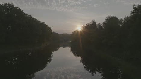 Während-Des-Sonnenuntergangs-über-Den-Noch-Reflektierenden-Fluss-In-Der-Natur-Fliegen