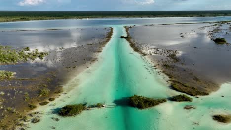 Aerial-view-over-the-lake-Bacalar-and-the-Lagoon-of-Seven-Colors,-in-sunny-Mexico---rising,-drone-shot