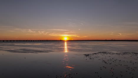 Reverse-reveal-of-sunset-over-marsh-near-Mobile-Bay,-Alabama