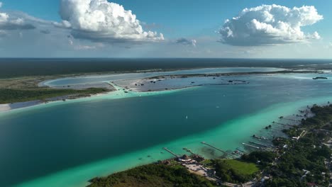 Aerial-view-overlooking-the-lake-Bacalar-and-the-Lagoon-of-Seven-Colors,-in-Quintana-roo,-Mexico---circling,-drone-shot