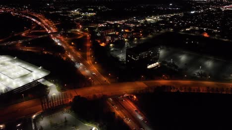 An-aerial-view-over-illuminated-roads-with-an-orange-glow-at-night
