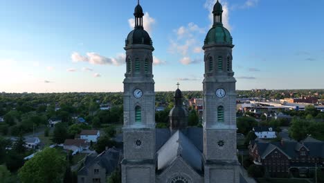 An-aerial-view-of-the-Saint-Stanislaus-B-and-M-Roman-Catholic-Church-spires-in-Buffalo,-New-York-in-the-light-of-the-setting-sun